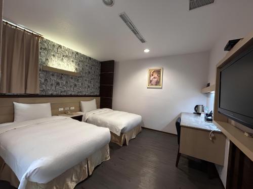 Postel nebo postele na pokoji v ubytování 花鄉商旅 左營店 Hua Xiang Hotel-Zuoying