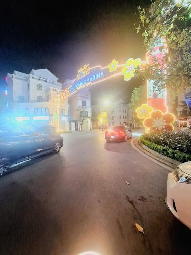a city street with cars parked in front of a building at TC Apartment & Homestay in An Khê