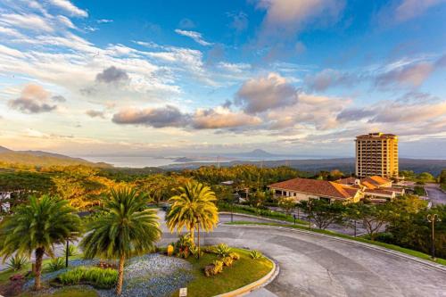 arial view of a city with palm trees and a building at Splendido Tagaytay Hotel and Country Club in Tagaytay