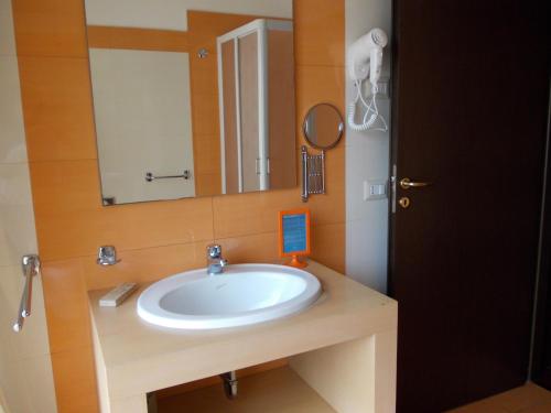 a bathroom with a sink and a mirror at Hotel Catania Town in Catania