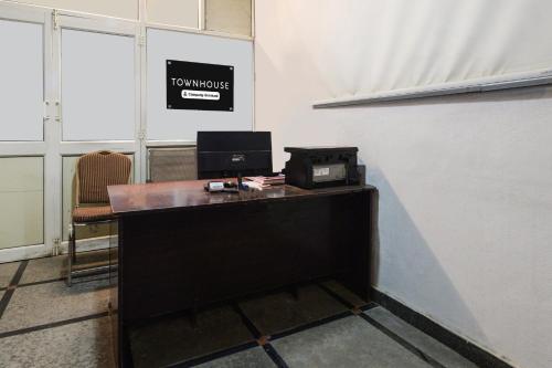 an office with a desk with a computer on it at Super Townhouse Alwal Road in Hyderabad