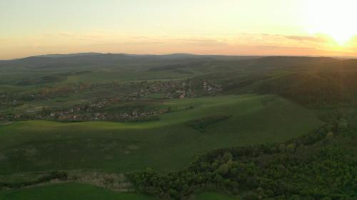 an aerial view of a town in a green field at Palócföldi Menedék in Kazár