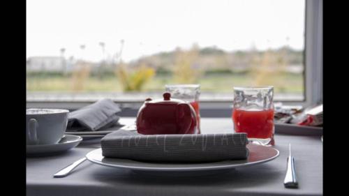 a table with a plate of food and a glass of ketchup at Hotel Zodiaco in Porto Cesareo