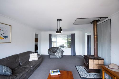 a living room with a couch and a table at Getaway 1 in Esperance