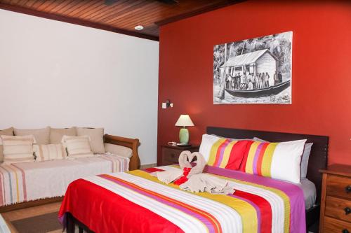 a bedroom with two beds with a teddy bear on the bed at Nid'Aigle Lodge in Anse Possession