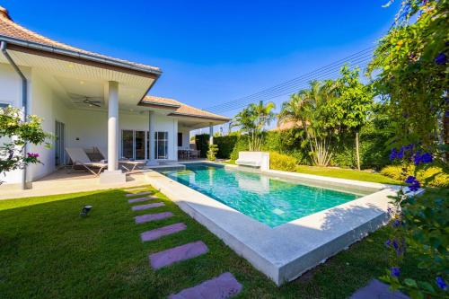 a swimming pool in the backyard of a house at 4 Bedroom Private Pool Villa - MR51 in Hua Hin