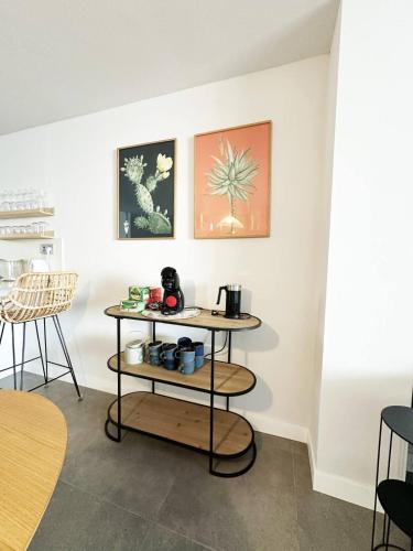a room with a table and chairs and paintings on the wall at Sea view apartments with Year-Round Open Pool in Manilva