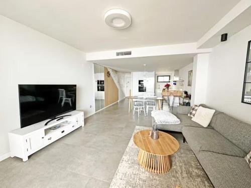 a living room with a couch and a table at Sea view apartments with Year-Round Open Pool in Manilva