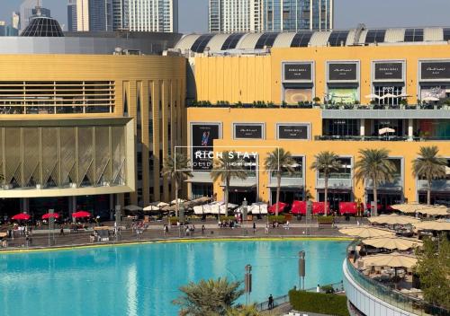 a large swimming pool in front of a building at Spectacular 2BR in Souk Al Bahar, Downtown with Burj & Dubai Mall view by Rich Stay in Dubai