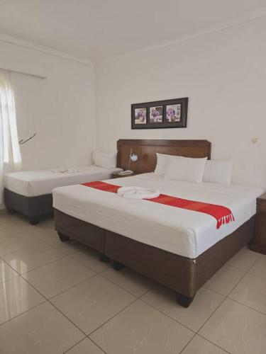 two beds in a hotel room with at The Wild Thing Guesthouse in Serowe