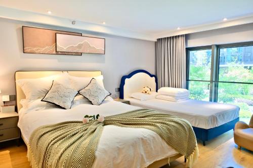Katil atau katil-katil dalam bilik di Zhujiajian Chunyu Qiushe Apartment