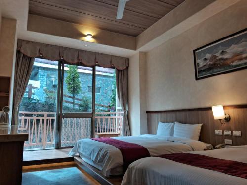 Ein Bett oder Betten in einem Zimmer der Unterkunft Ku Kuan Resort Hotel
