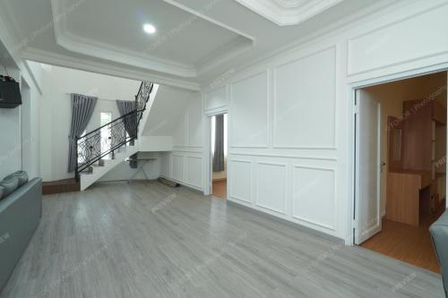 an empty living room with white walls and a staircase at Villa Fiorenza I in Sampal 2