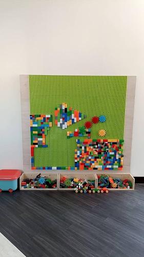 a lego wall with a pile of legos on the floor at 藍月金門民宿 in An-ch'ien