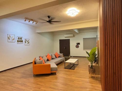 a living room with a couch and a table at 2-16 pax 5BR, 4 bathrooms, 5km to TC beach in Kuantan