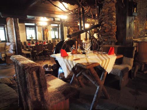 a dining room with a table and chairs in a restaurant at Momini Dvori Boutique Guest House in Bansko