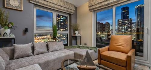 a living room with a couch and a large window at Reem Island Beach Haven with Stellar Balcony Views in Abu Dhabi