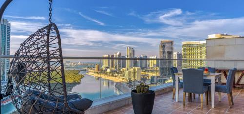 a balcony with a view of a city at Reem Island Beach Haven with Stellar Balcony Views in Abu Dhabi