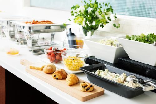 a kitchen counter with a bunch of food on it at the b hachioji in Hachioji