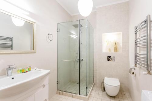 a bathroom with a shower and a toilet and a sink at Central Elegant Apartment in Tbilisi City