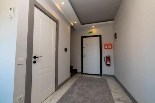 a hallway with a white door and a white wall at Seda Holiday in Alanya