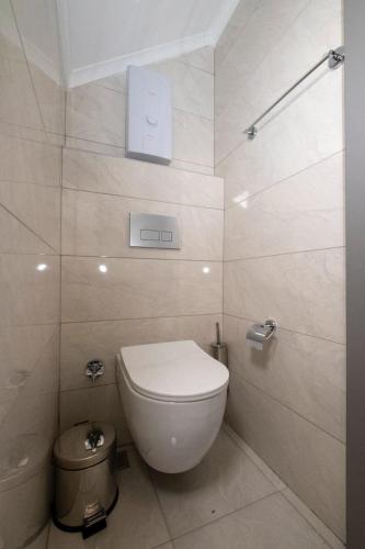 a bathroom with a toilet and a trash can at Seda Holiday in Alanya