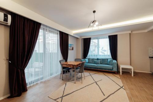 a living room with a couch and a table at Fortunella Suites in Finike