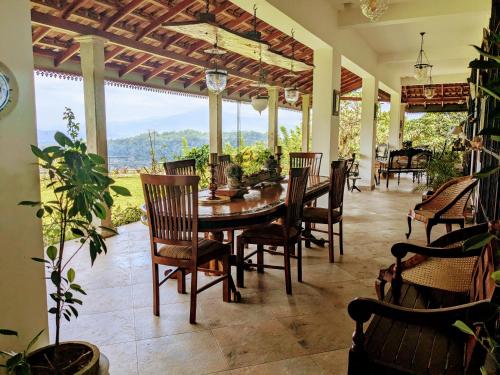 a dining room with a table and chairs at Namadi heights Bungalow in Kandy
