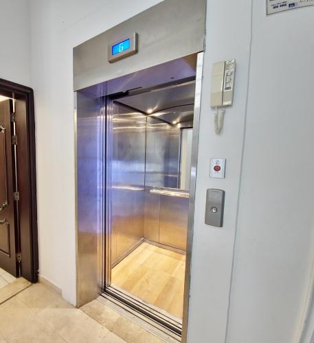 a elevator in a building with a walk in closet at HARF22-02 Peaceful 2BR in Abu Dhabi city in Abu Dhabi