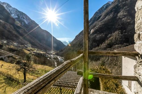 a view from the balcony of a house in the mountains at Rustico Over The Bridge Verzasca in Lavertezzo