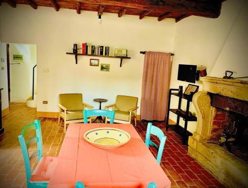a room with a table and chairs and a fireplace at Il Vicolo apartment in the village in Manziana