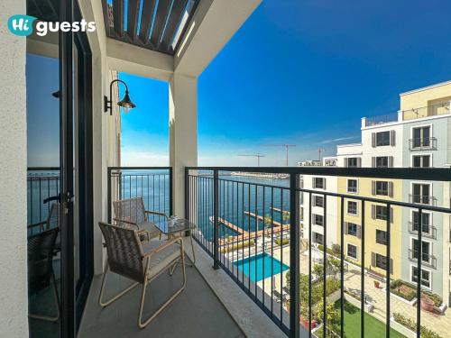 a balcony with a chair and a view of a building at HiGuest - Stylish 1BR Apartment in La Mer in Dubai