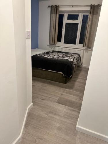 a bedroom with a bed and a window at Basildon Everlight Villa in Basildon