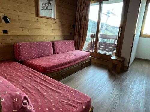 un salon avec un canapé et une fenêtre dans l'établissement Résidence Cristallin - Le Cristallin 33 - Agréable 2 pièces au pied des pistes MAE-5454, à Valmorel