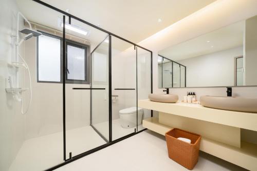 a bathroom with two sinks and a glass shower at 大理麓屿悬崖海景民宿 in Dali