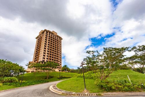 a tall building on a hill next to a road at Splendido Tagaytay Hotel and Country Club in Tagaytay