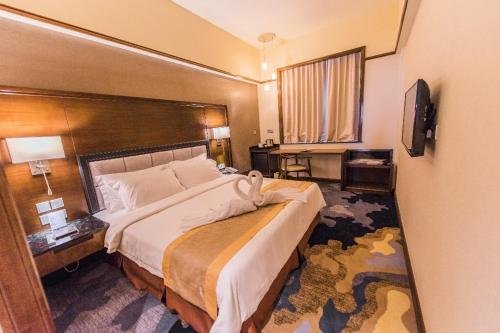 Postel nebo postele na pokoji v ubytování NU Hotel