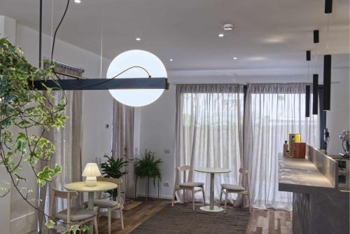 a living room with a table and chairs at Agave in Centrale in Milan