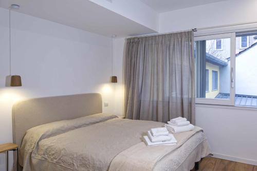 a bedroom with a bed with towels on it at Agave in Centrale in Milan