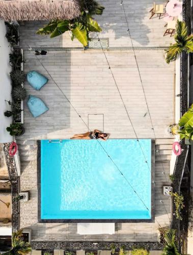 an overhead view of a swimming pool with a woman laying on it at Icon Saigon - LifeStyle Design Hotel in Ho Chi Minh City