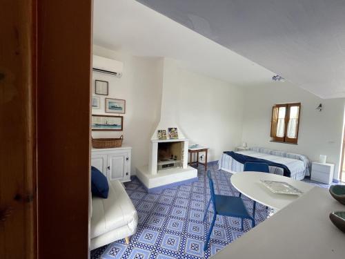 a living room with two beds and a fireplace at Casa a' Gnazia in Santa Marina Salina