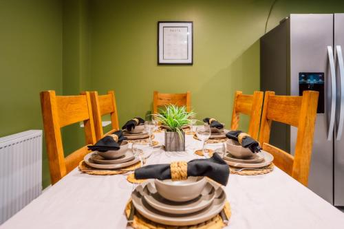 a dining room table with hats on top of it at Dalmarnock Stay in Glasgow