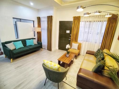 a living room with a couch and a table at Noah's Crib for Families and Big Groups in Cebu City