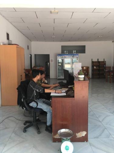two men sitting at a desk working on their computers at Vientiane Garden Hostel Zone B in Vientiane