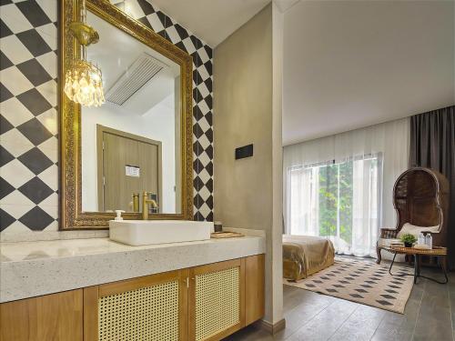 a bathroom with a sink and a mirror at Muse Garden in Shanghai