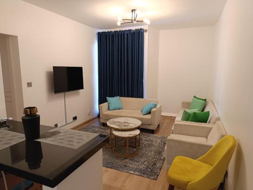 a living room with a couch and a table at Unity 1 in Tatu City