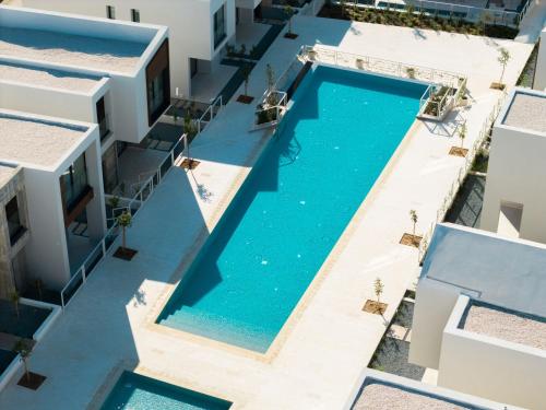 an overhead view of a swimming pool between two buildings at Avalon Gardens Villa 21 in Emba