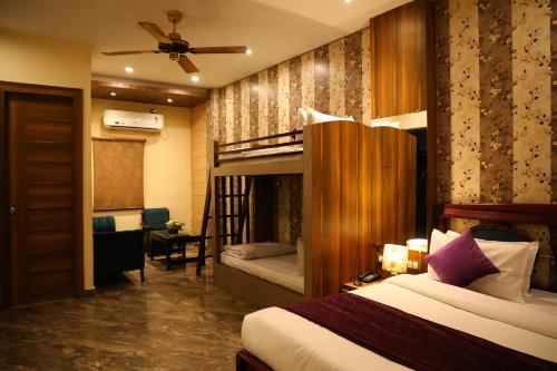 a bedroom with a bunk bed and a ladder to a bunk bed at Perfectstayz Premium Ganga Heights at Harkipauri Road in Haridwār
