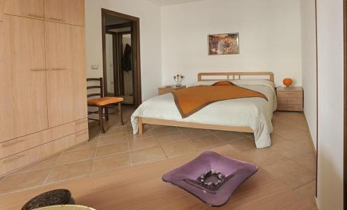 a bedroom with a bed and a purple rug at Terrazza Paola in Alghero