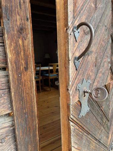 an old wooden door with a lock on it at HI Sjoa in Otta